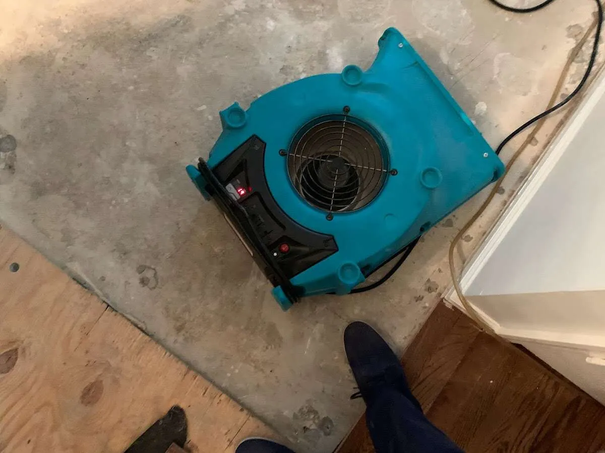 Air mover drying subfloor during Commercial Water Damage Restoration in Severn
